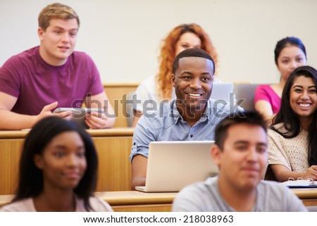 Students Using Laptops And Digital Tablets In Lecture