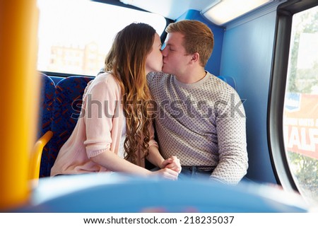 Romantic Teenage Couple Kissing On Bus