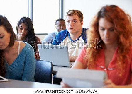 Male University Student Using Laptop In Classroom