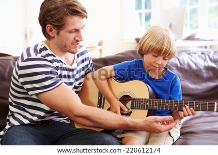 Father Teaching Son To Play Guitar Father Teaching Son To Play Guitar