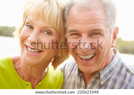 Head And Shoulders Portrait Of Senior Couple Outdoors