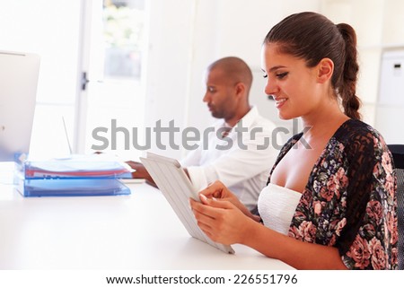 Woman Using Digital Tablet In Office Of Start Up Business