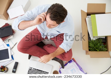 Overhead View Of Start Up Business Moving Into Office Overhead View Of Start Up Business Moving Into Office