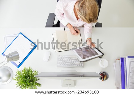 Overhead View Of Businesswoman Working At Computer In Office