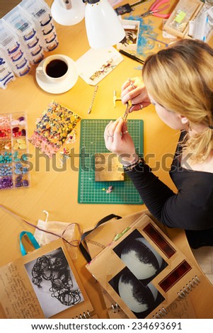Overhead View Of Woman Making Jewelry At Home