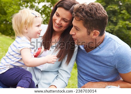Family Playing Game In Garden With Daughter