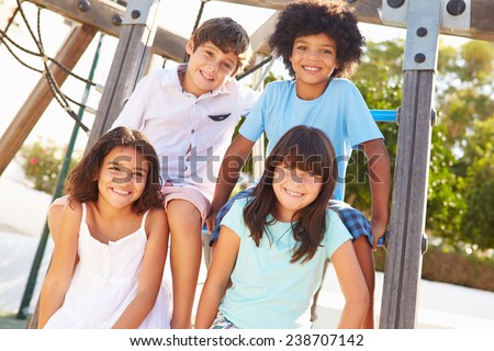 Group Of Children On Playground Climbing Frame