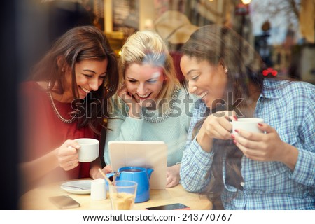 Group Of Female Friends In CafÃ?Â¢?? Using Digital Devices