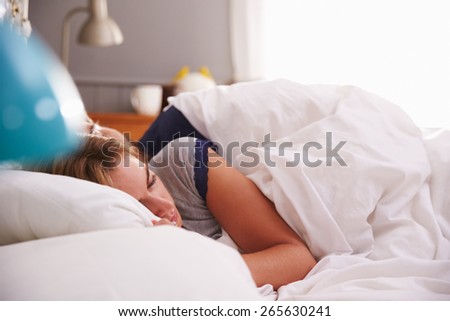 Young Couple Asleep in Bed Together