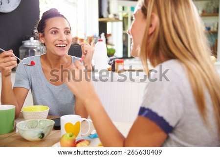 Two Female Friends Enjoying Breakfast At Home Together