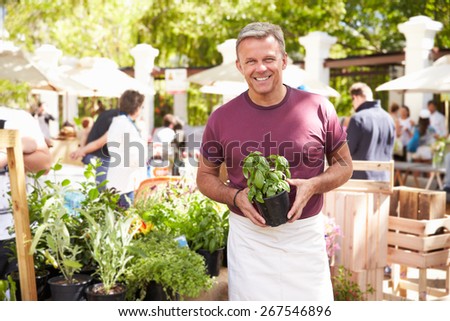 Man Selling Herbs And Plants At Farmers Food Market