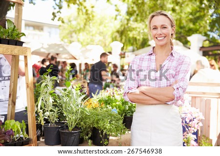 Woman Selling Herbs And Plants At Farmers Food Market