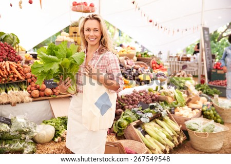 Female Customer Shopping At Farmers Market Stall