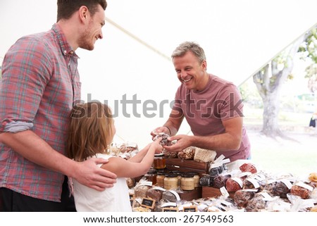 Family Buying Nuts From Stall At Farmers Market