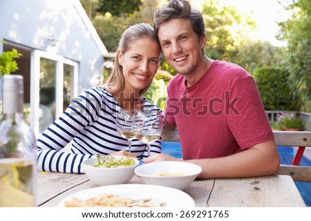 Couple Enjoying Outdoor Drinks In Garden