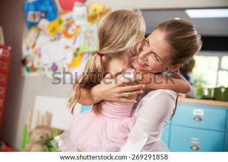 Daughter Hugging Mother Returning From Work
