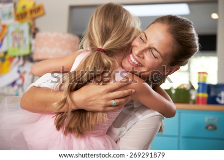 Daughter Hugging Mother Returning From Work