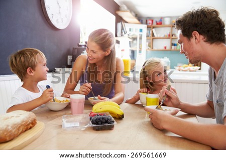 Family Eating Breakfast At Kitchen Table