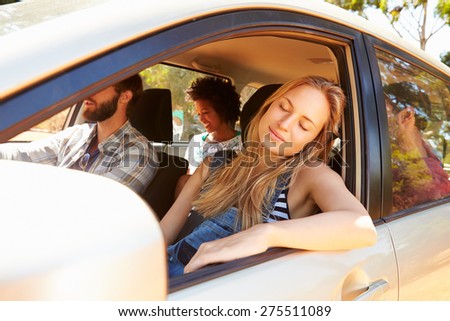 Group Of Friends In Car On Road Trip Together
