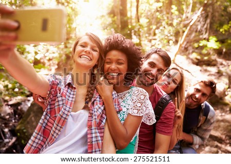 Group Of Friends On Walk Taking Selfie In Forest