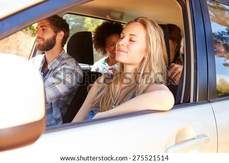 Group Of Friends In Car On Road Trip Together