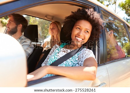 Group Of Friends In Car On Road Trip Together