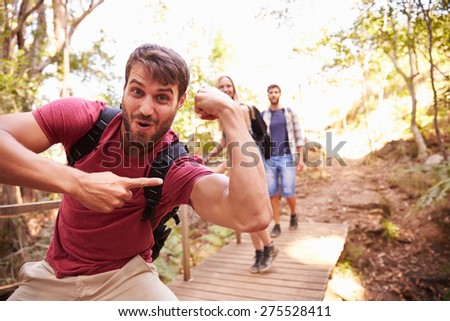 Man On Walk With Friends Making Funny Gesture At Camera
