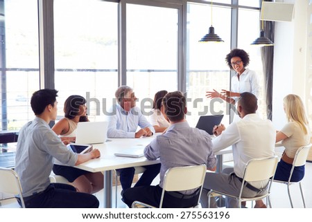 Businesswoman presenting to colleagues at a meeting