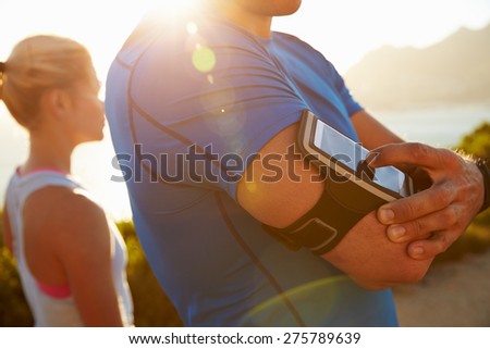 Man putting music on before running
