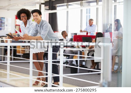 Staff working in a busy office mezzanine