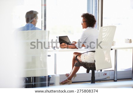 Two people working in a modern office