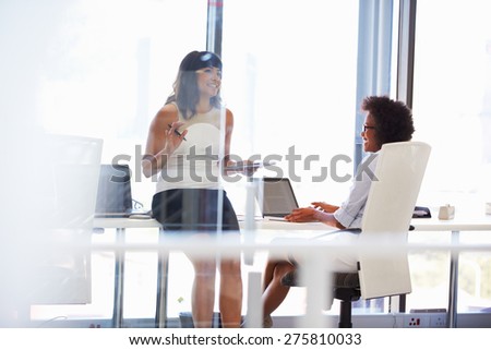 Two women talking in an office