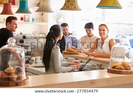 Woman ordering at the counter in a cafe