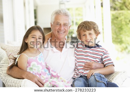 Grandfather With Grandchildren At Home