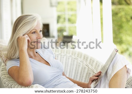Senior woman reading outside