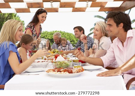 Extended Family Group Enjoying Outdoor Meal Together