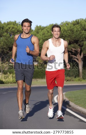 Two Men Running On Road
