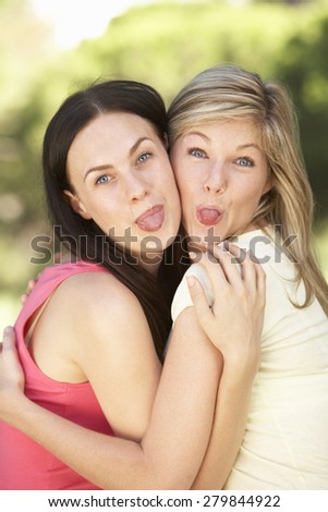 Two Female Friends Pulling Faces Together