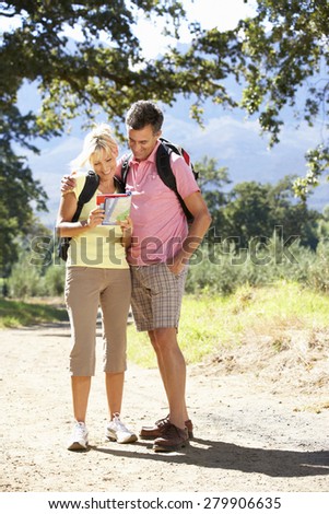 Middle Aged Couple Hiking Through Countryside