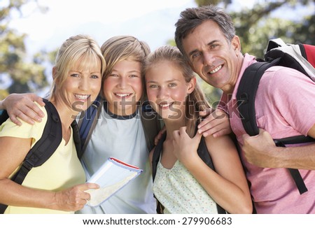 Middle Aged Family Hiking Through Countryside
