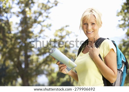 Middle Aged Woman Hiking Through Countryside