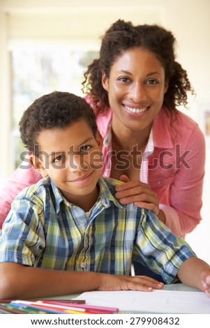 Mother Helping Son With Homework At Home