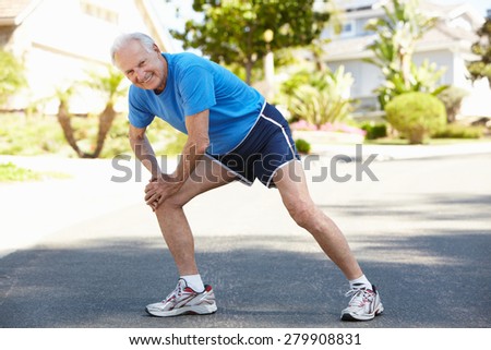 Elderly man warming up for run