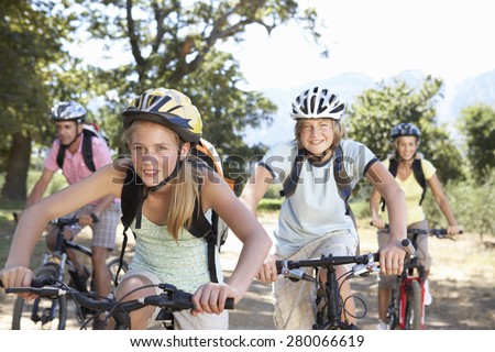 Family Cycling Through Countryside