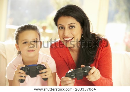 Mother And Daughter Playing Video Game At Home