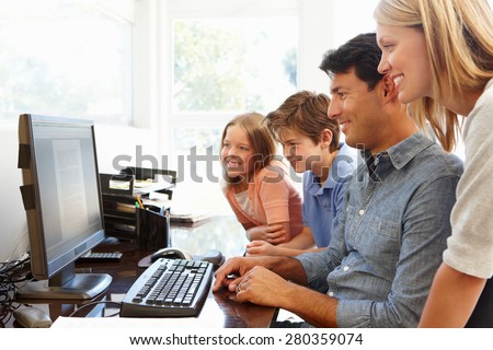 Family with computer in home office