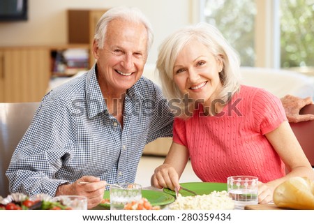 Father and adult daughter sharing meal
