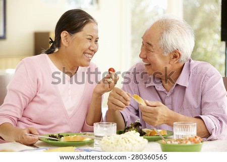 Senior asian couple sharing meal at home