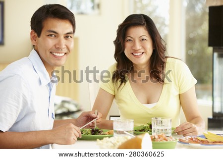 Asian couple sharing meal at home
