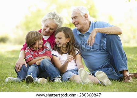Senior couple and grandchildren in park
